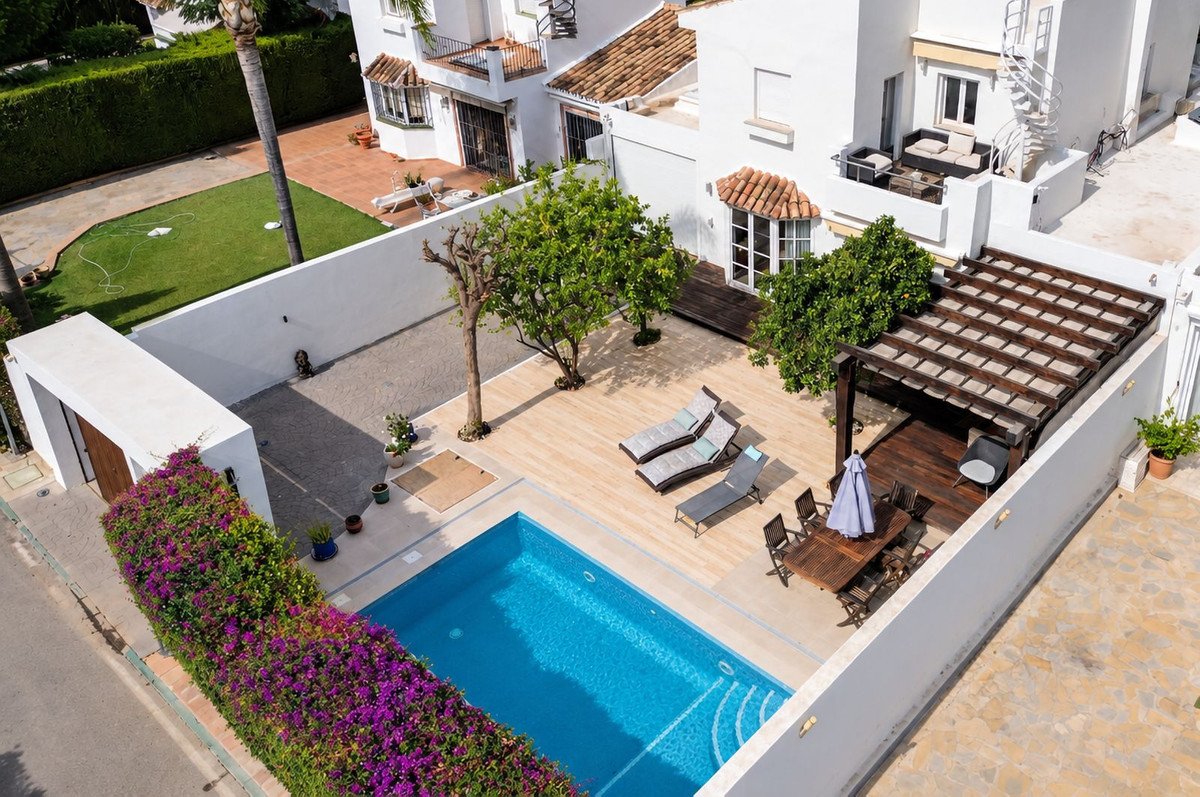 Villa with swimming pool, terrace, lounge chairs, and outdoor seating area