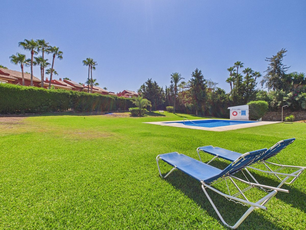 Outdoor swimming pool with lounge chairs on a sunny day