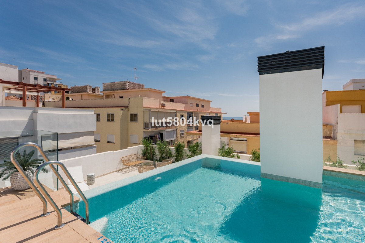 Swimming pool with view of residential neighborhood and clear blue sky