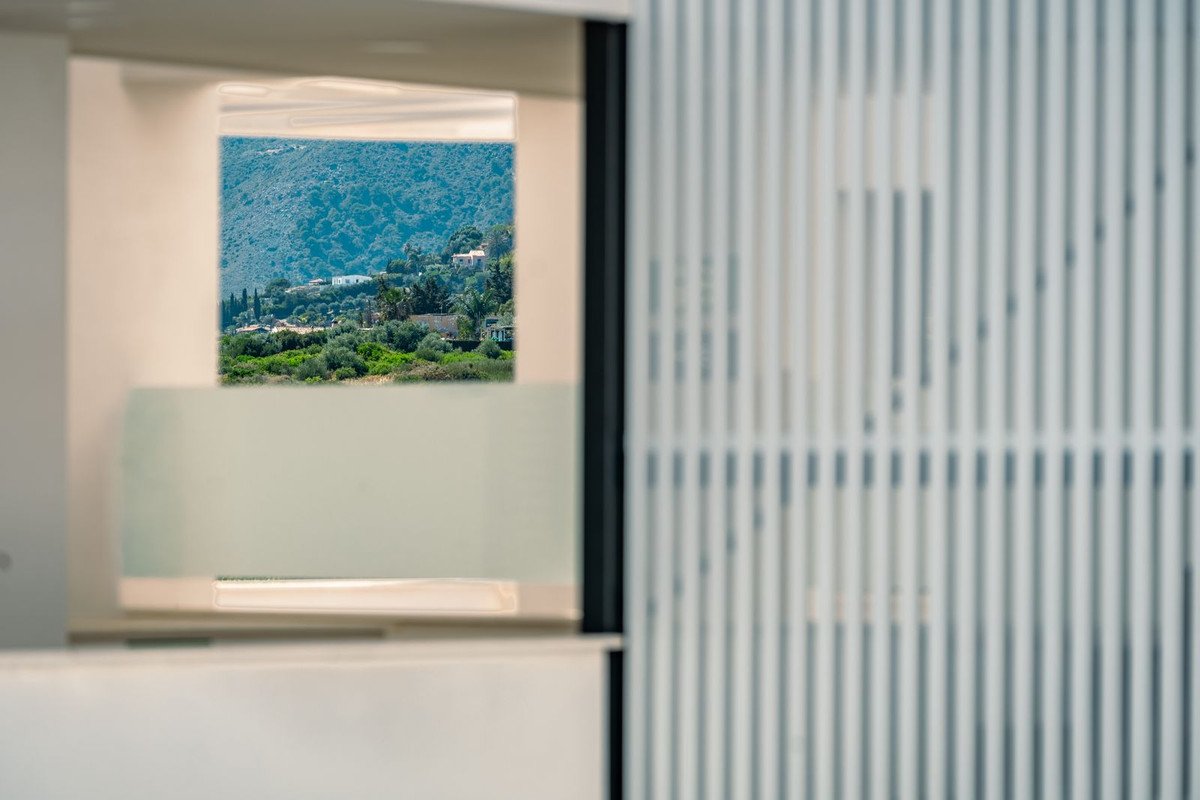 Mountain view through a large window with a scenic landscape outside