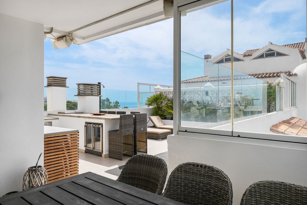 Modern outdoor lounge with seating area overlooking the sea