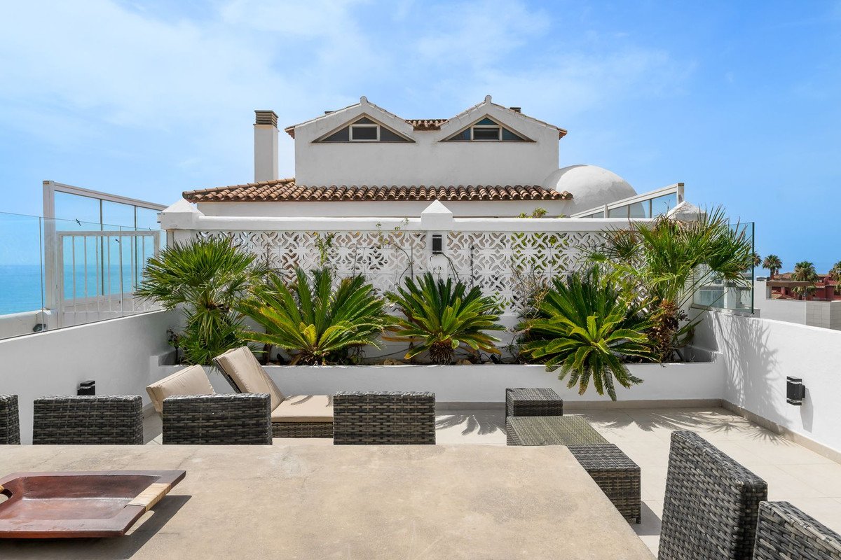 White house with tiled roof and sea view terrace