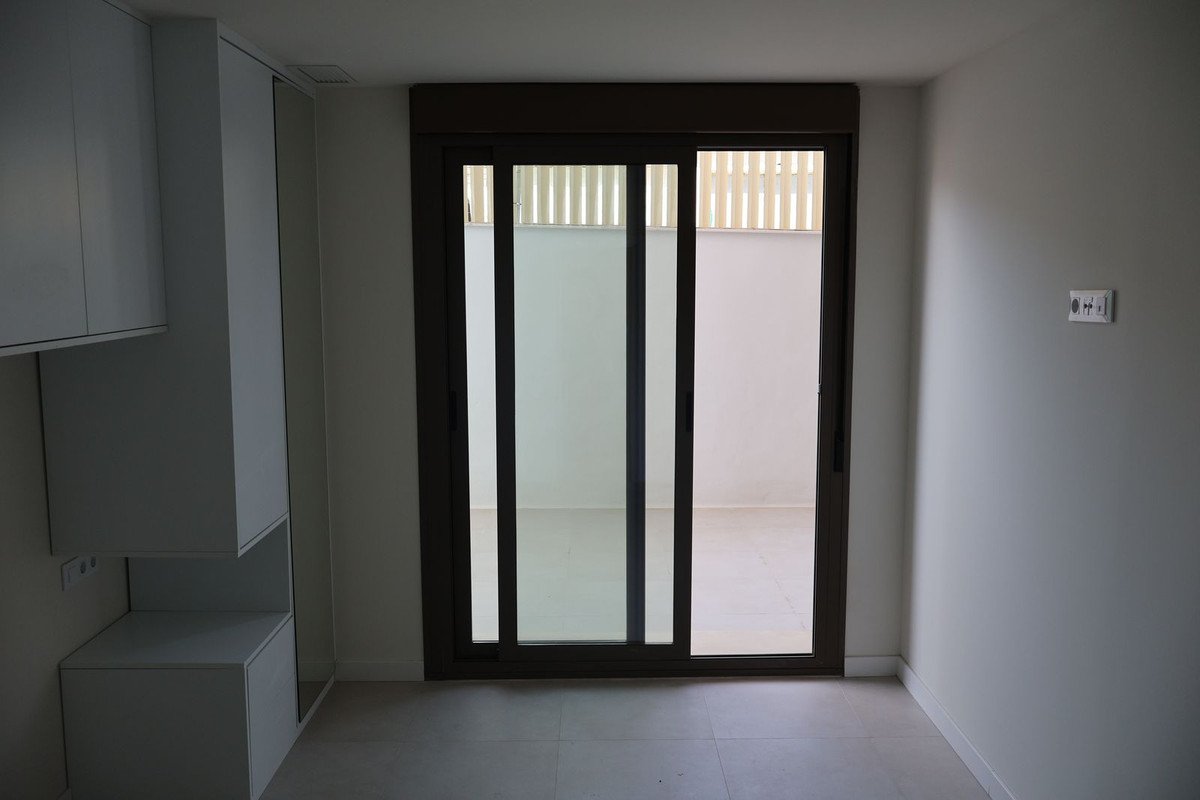 Modern entryway with sliding glass doors and built-in cabinets