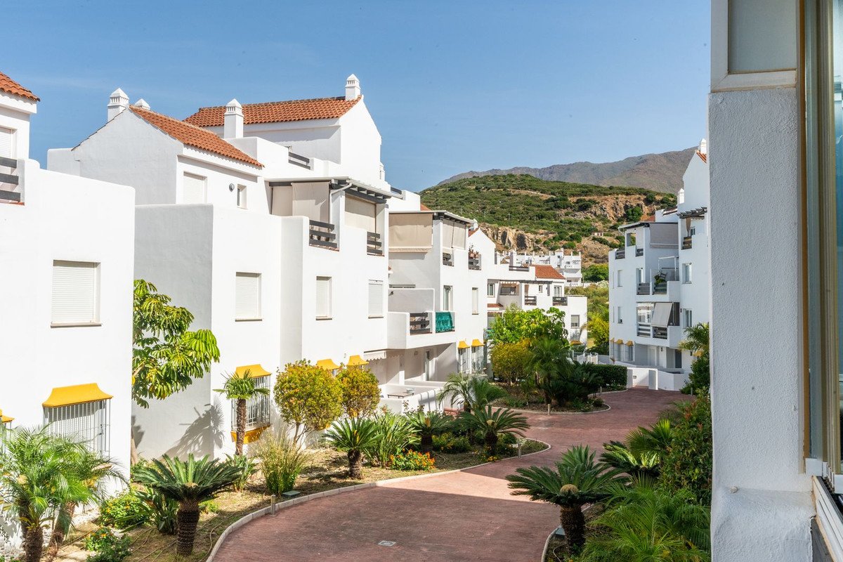 White apartments with garden and mountain view