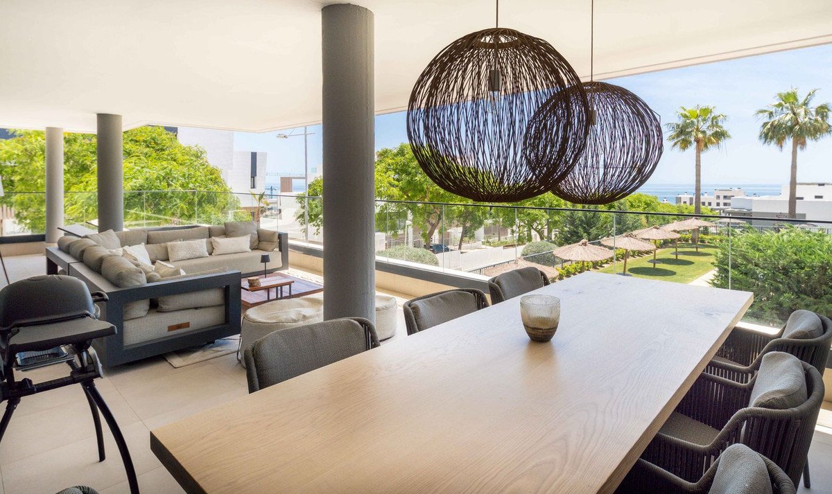 Modern living room with large dining table and ocean view