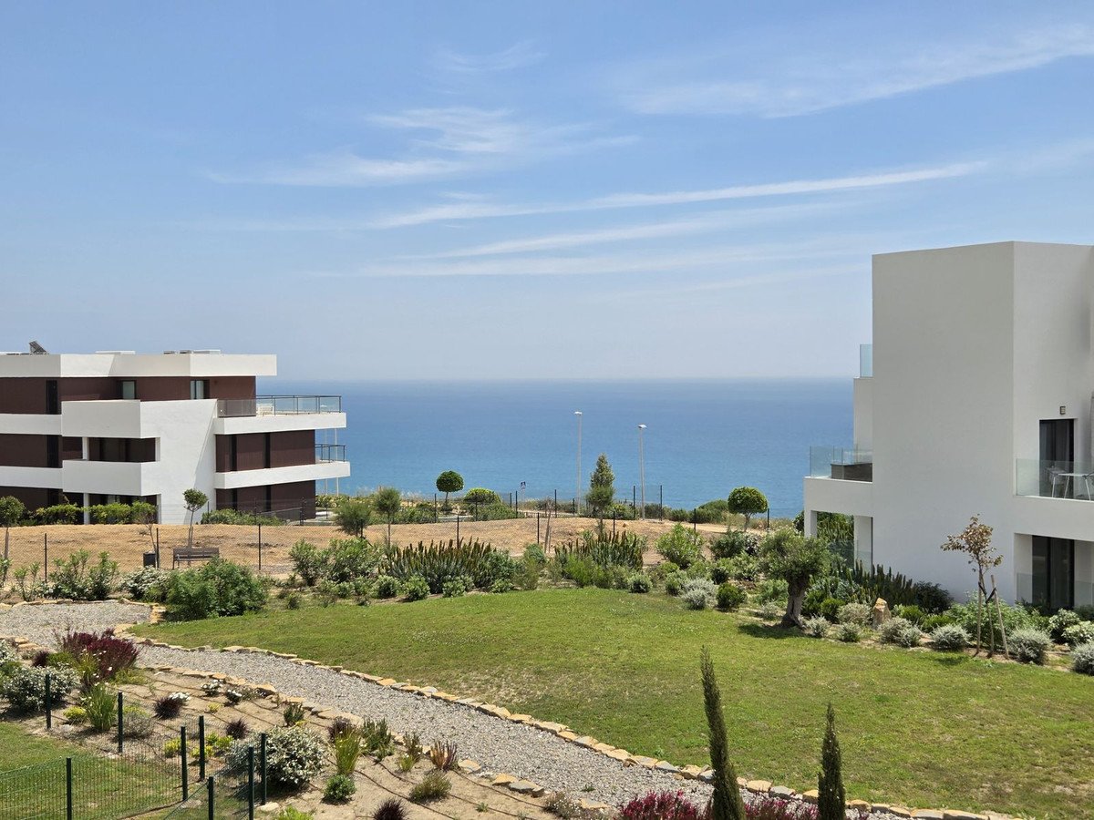 Modern white houses with landscaped garden and ocean view