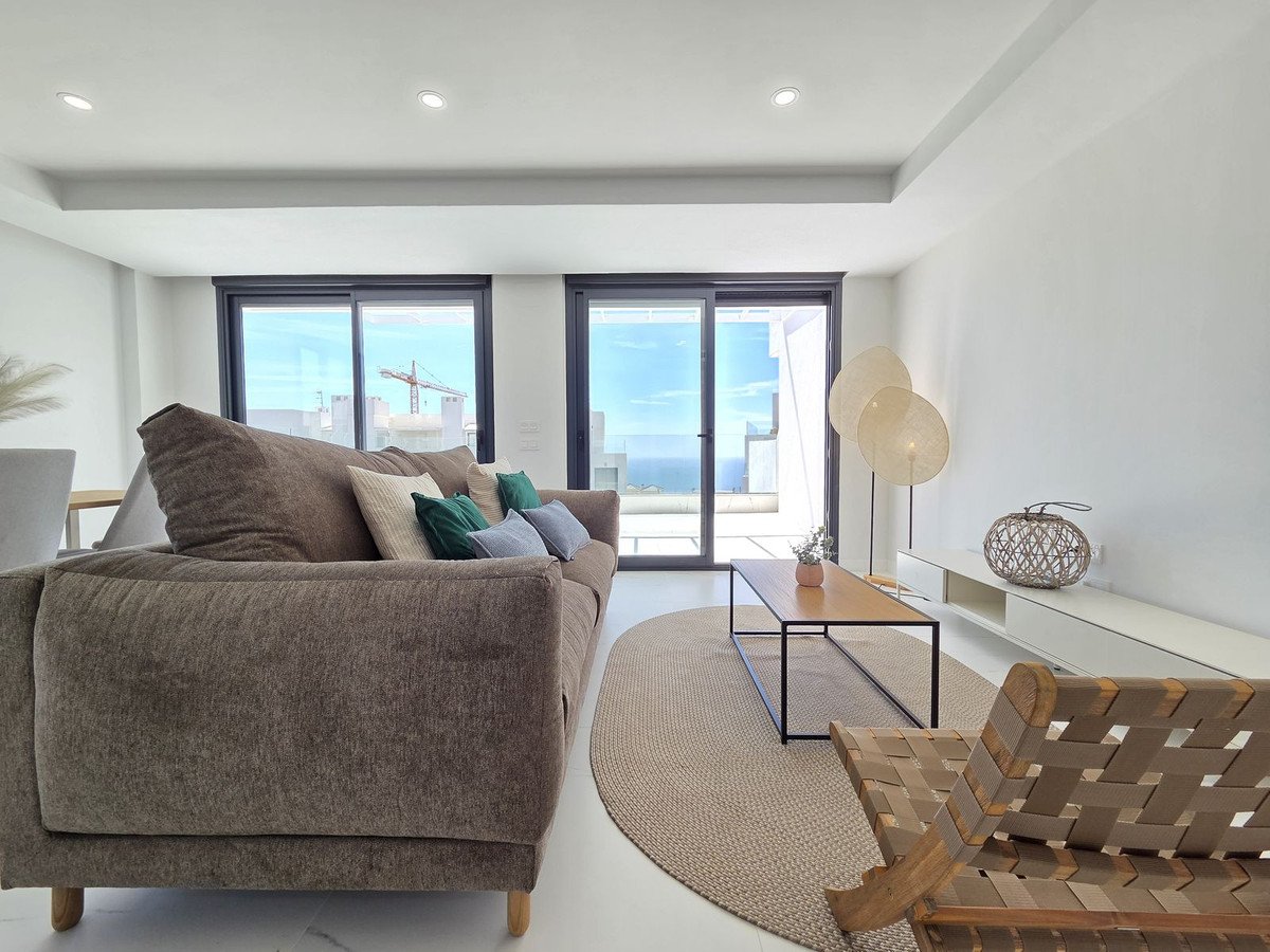 Modern living room with large windows overlooking the sea