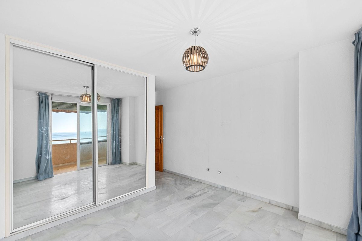 Modern living room with large windows overlooking the sea