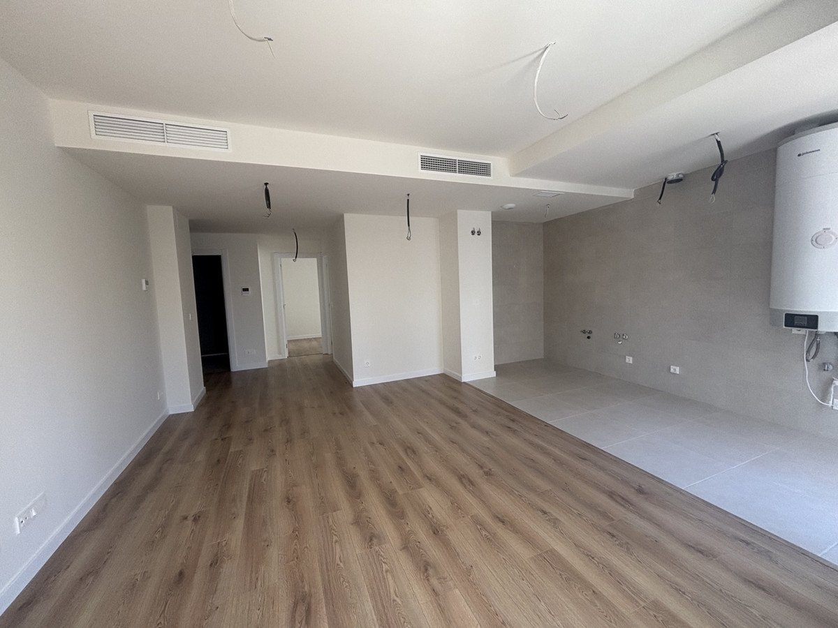 Empty living room with hardwood floor, air conditioning, and ceiling fans
