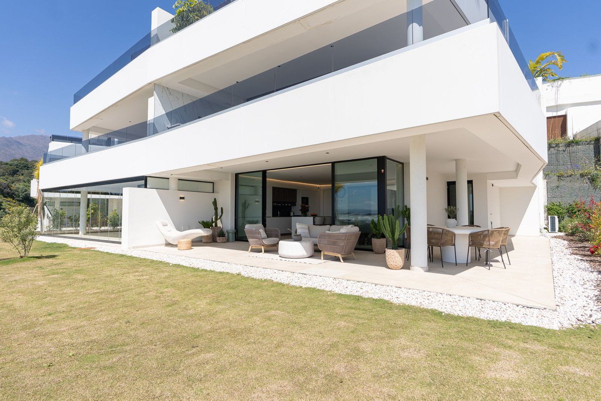 Modern white house exterior with outdoor seating and swimming pool area