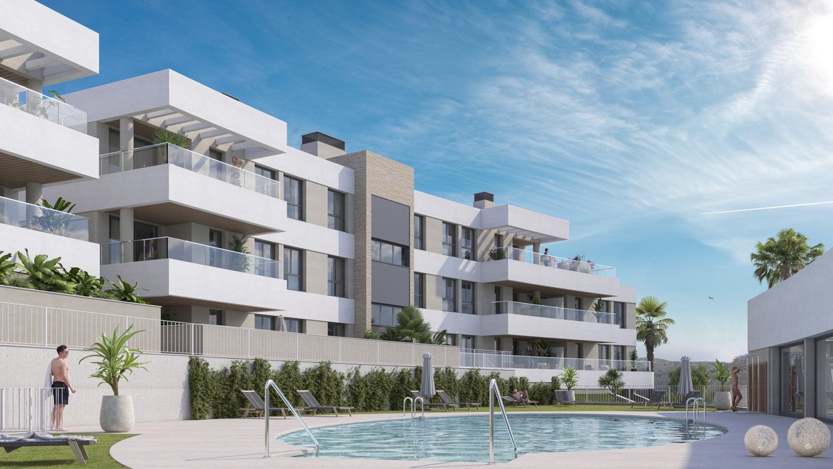 Modern apartment complex with swimming pool and clear blue sky