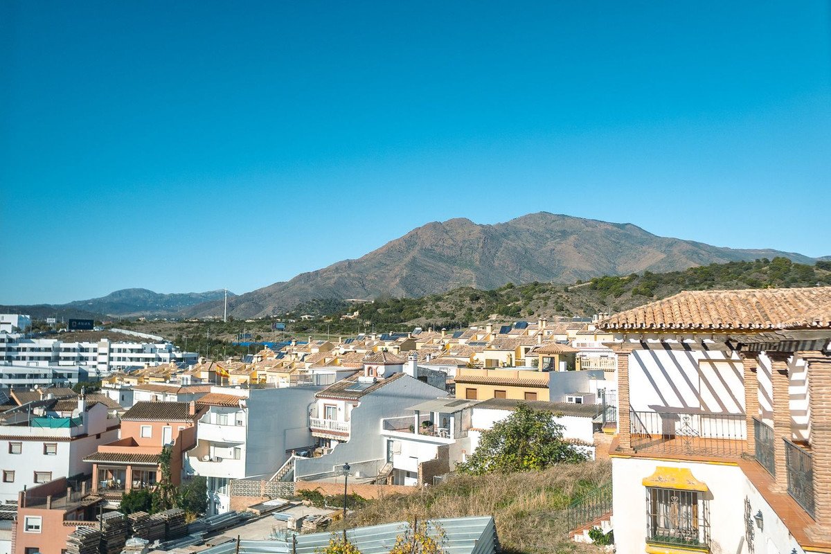 Town with colorful houses and mountain view under clear blue sky