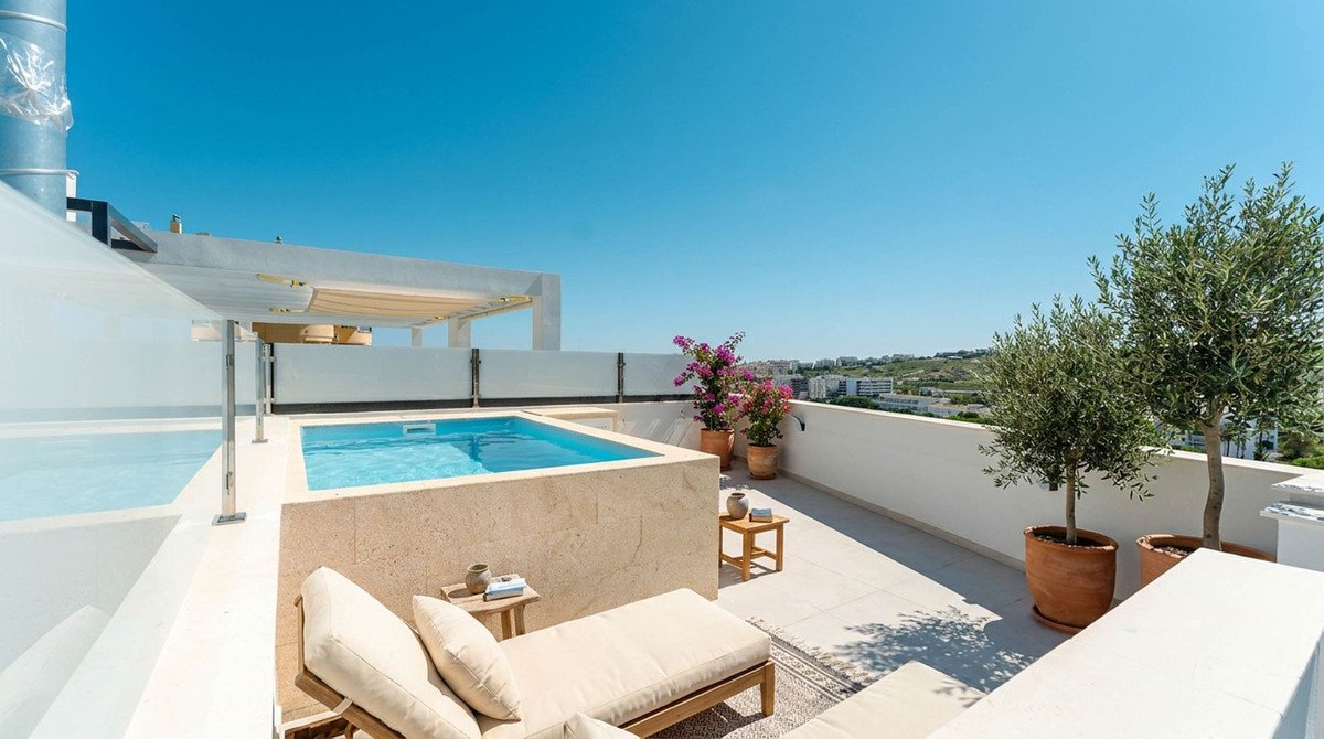 Modern swimming pool with lounge area and scenic view