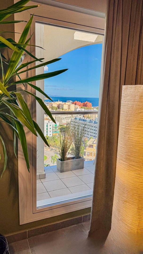 Balcony view with sea and cityscape in the background