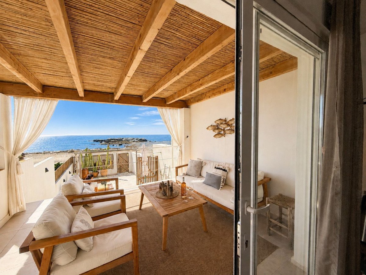 Cozy lounge area with wooden furniture and ocean view
