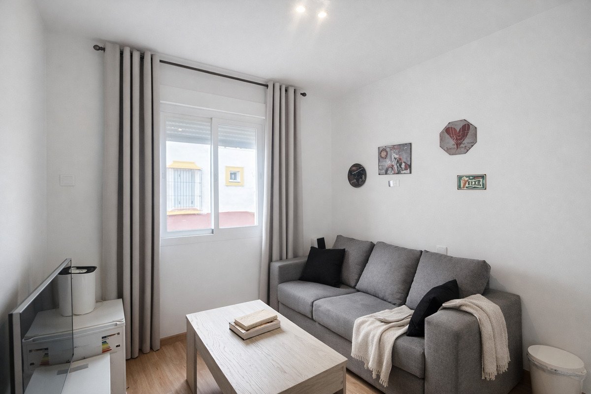Modern living room with gray sofa, large window, and minimalist decor
