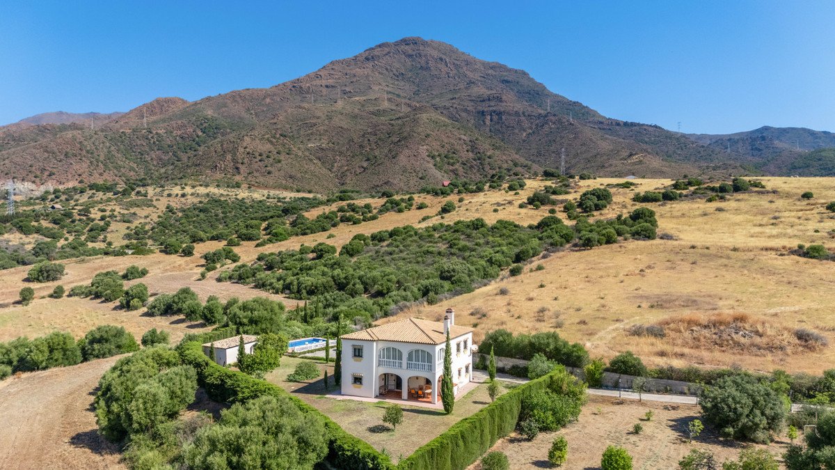 Luxury home with terracotta roof nestled in a scenic mountain landscape