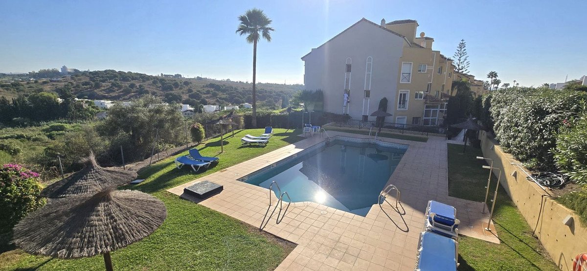 Villa with swimming pool, lounge chairs, and scenic landscape views
