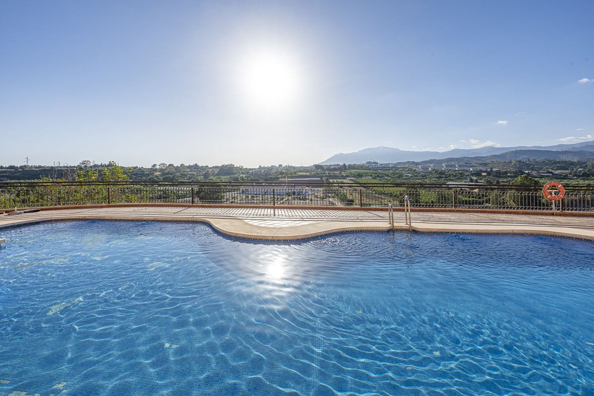 Outdoor swimming pool with clear blue water and sunny mountain view