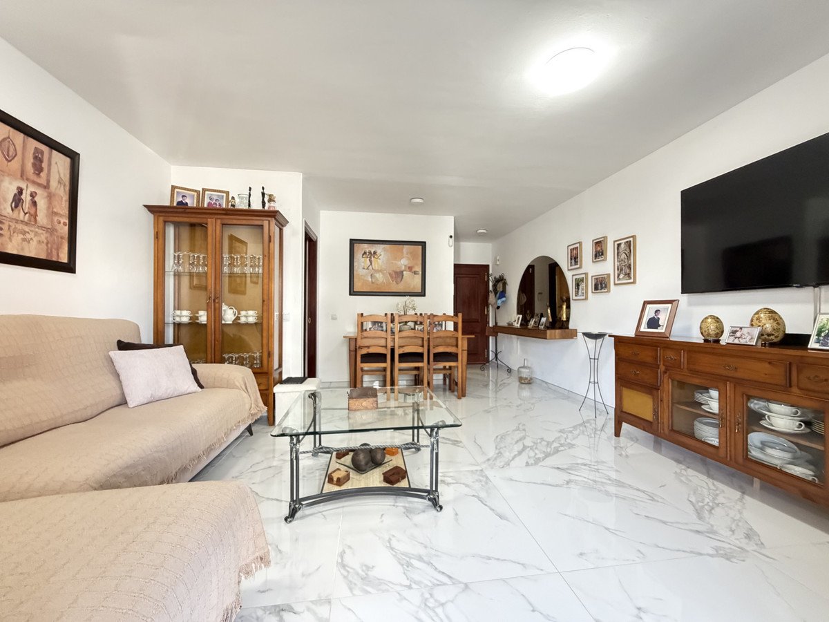 Spacious living room with open plan layout and marble floors