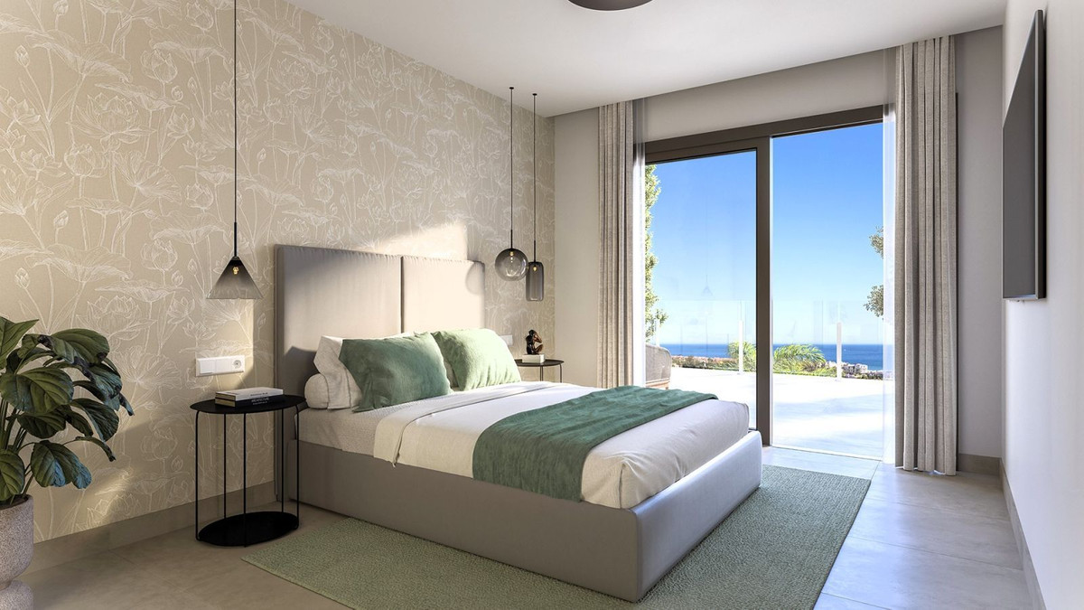 Moderne slaapkamer met uitzicht op de oceaan.