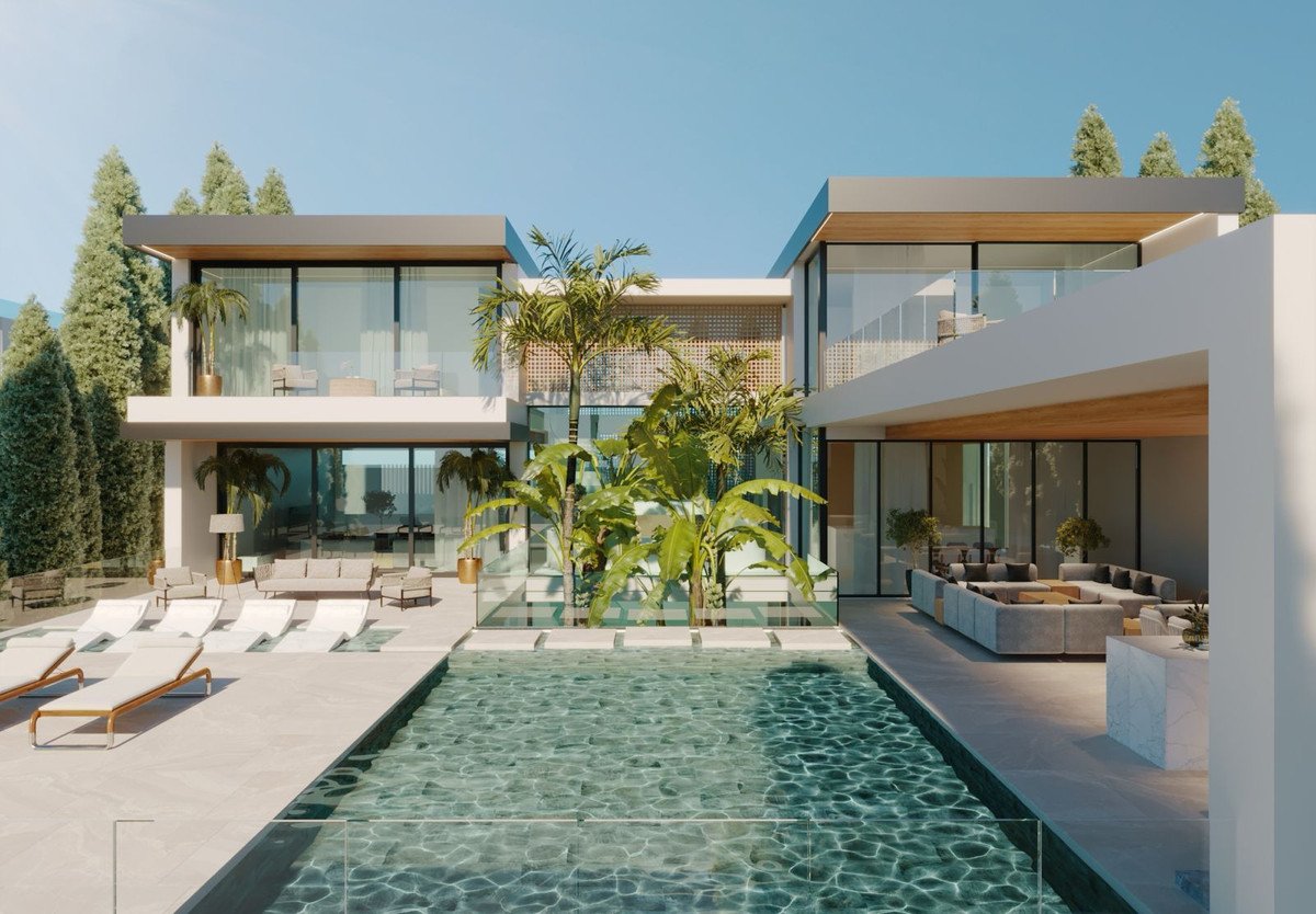 Modern luxury mansion with infinity pool, lounge area, and palm trees, offering outdoor living spaces.