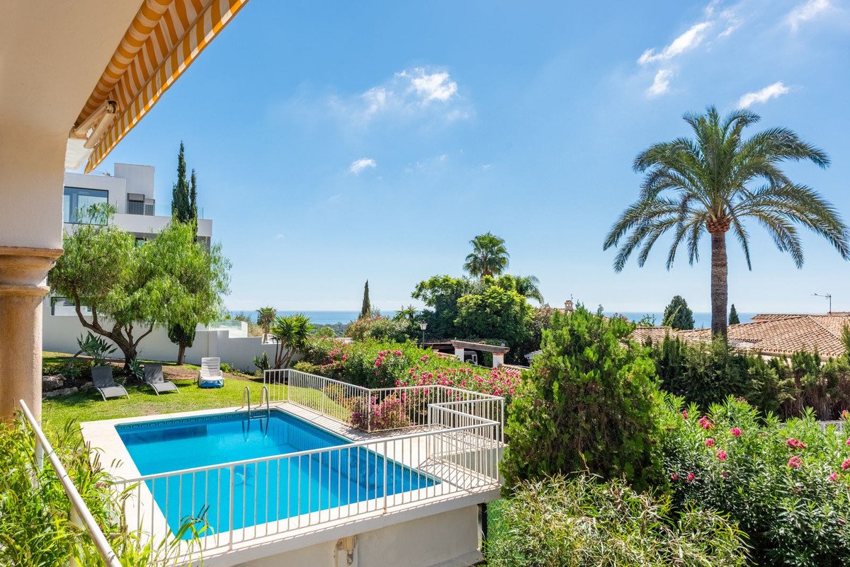 A private swimming pool and garden with sea views, ideal for relaxation and outdoor living.
