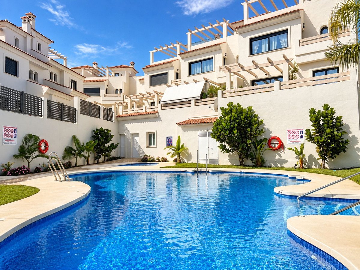 Bright blue swimming pool in a sunny apartment complex with white buildings