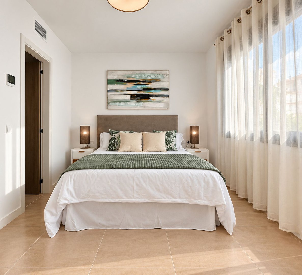 Modern master bedroom with king bed, abstract art, and large window with sheer curtains