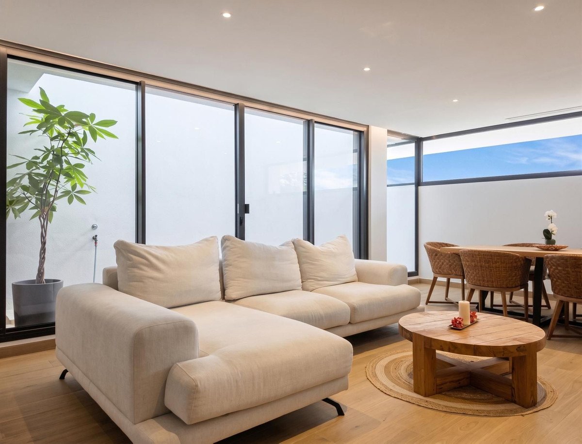 Modern living and dining area with a sectional sofa, coffee table, dining set, and large windows with natural light.