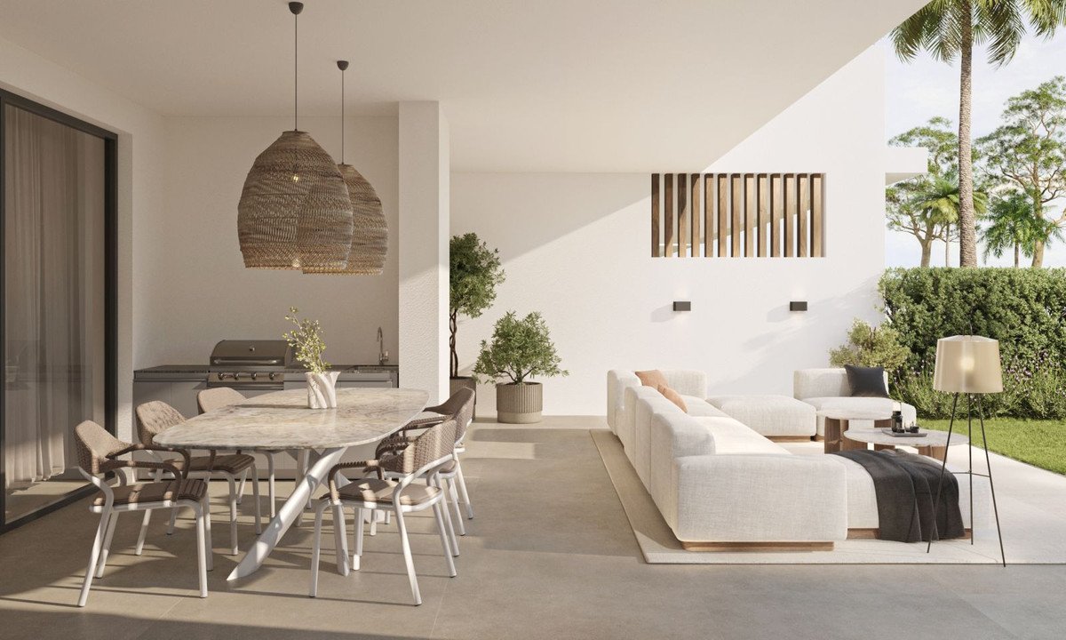 Modern outdoor living and dining area with patio furniture and tropical garden view