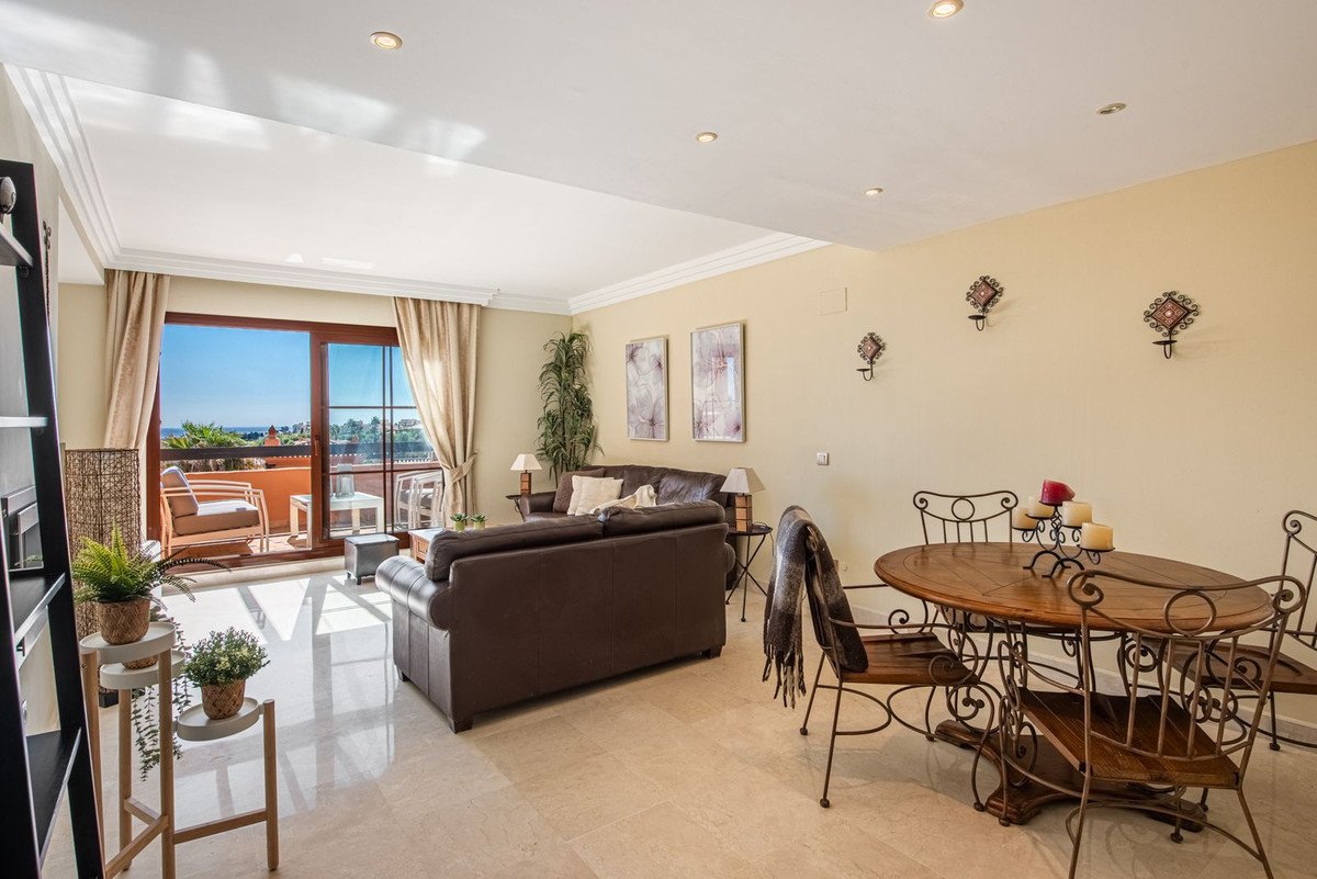 Spacious living and dining room with sea view and balcony access