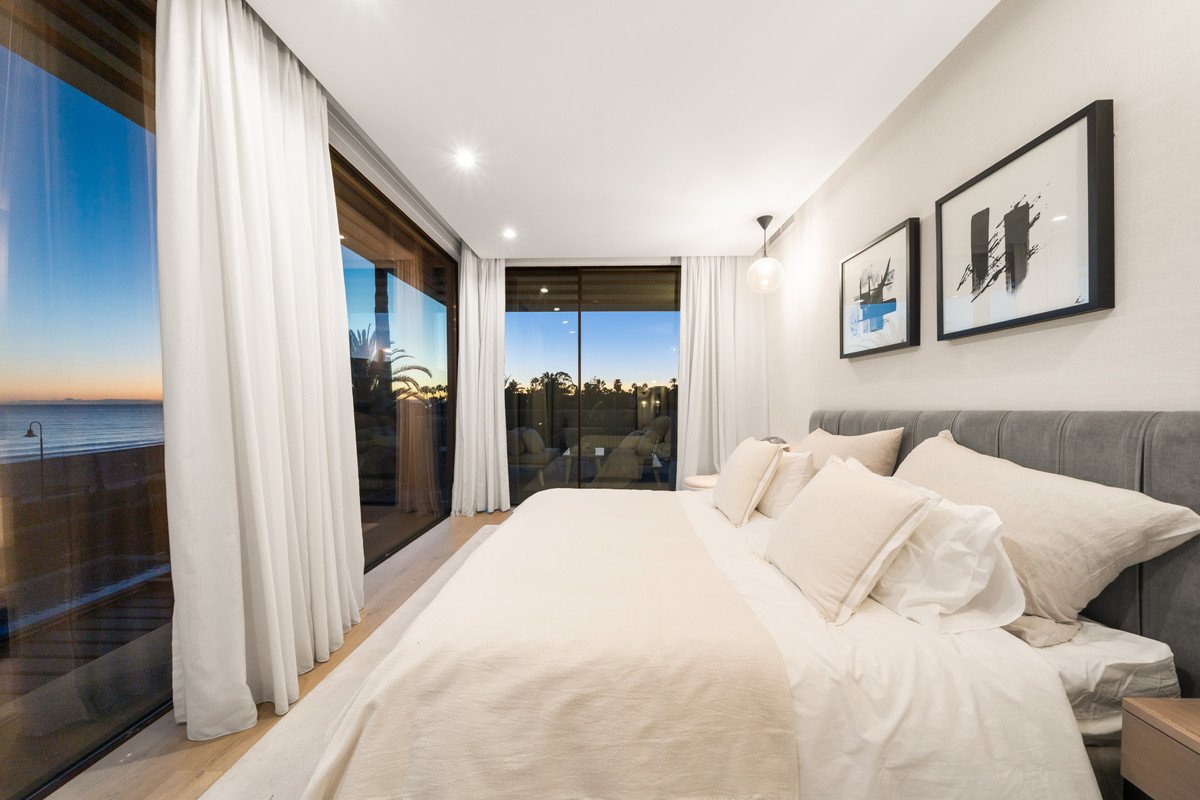 Modern bedroom with ocean view and large windows