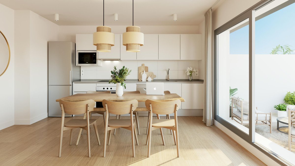 Modern kitchen with large windows, wooden dining table, and open living space.