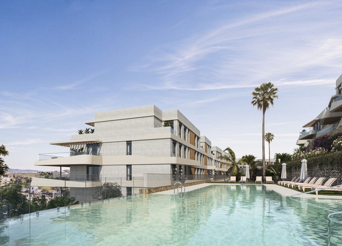 Modern apartment complex with a large swimming pool and palm trees.