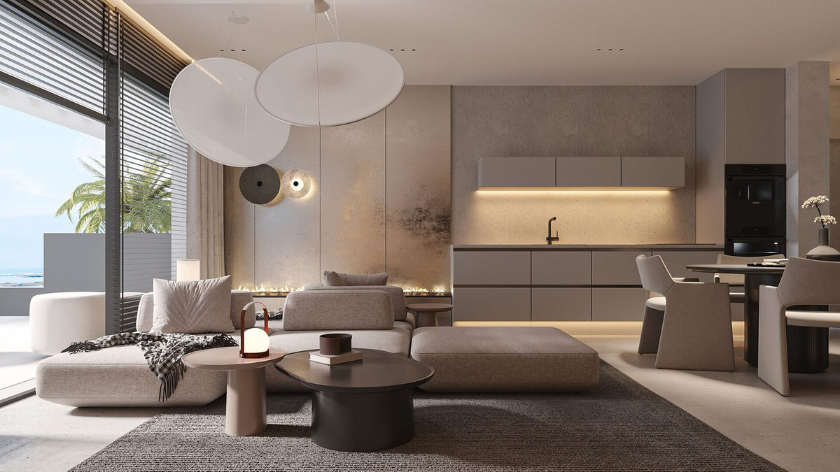 Moderne woonkamer met open keuken en uitzicht op zee.