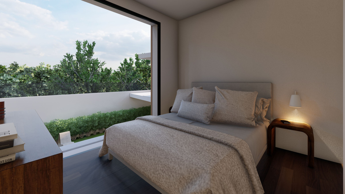 Moderne slaapkamer met uitzicht op het balkon en groen.