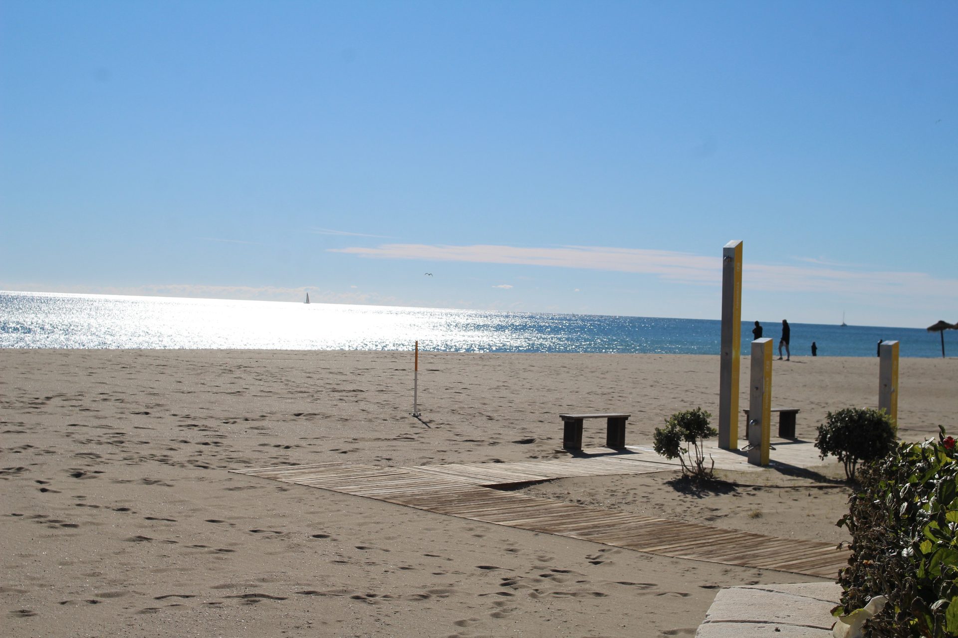 Beachfront room with ocean view, featuring a balcony and lounge chairs.