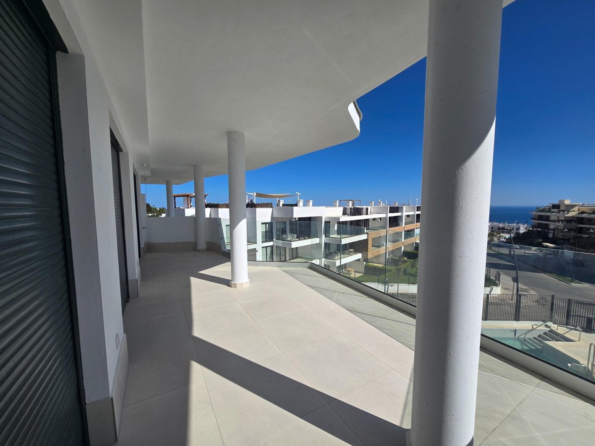 Modern apartment balcony with stunning sea views and contemporary architecture.