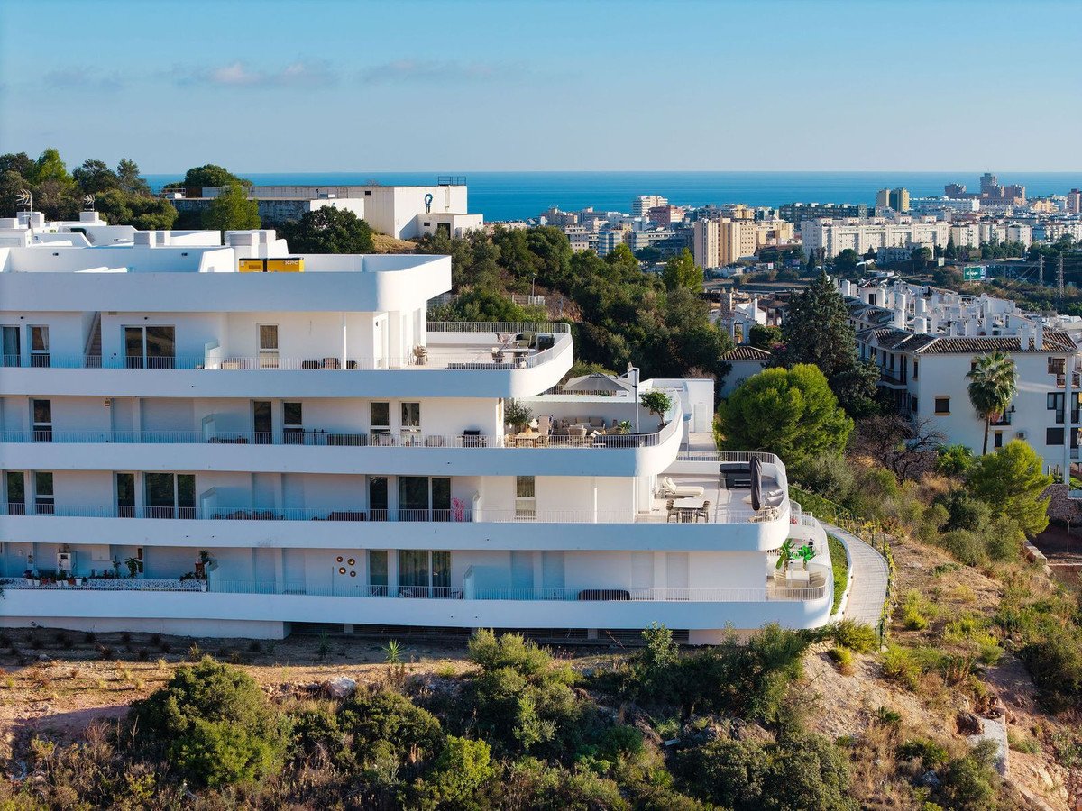 Modern white apartment building with sea view and terraces