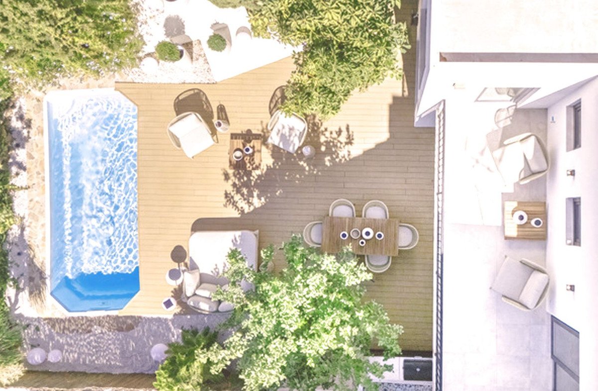 Aerial view of a modern patio with a swimming pool, outdoor dining set, and lounge seating.