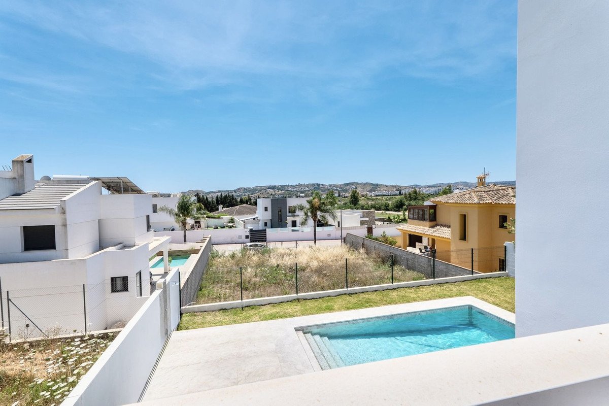 Swimming pool with view of a residential area and clear blue sky