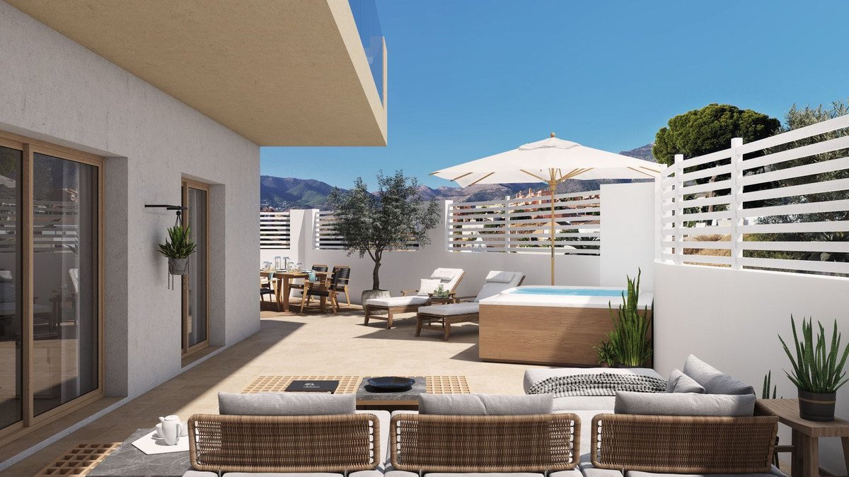Modern terrace with hot tub, loungers, dining area, and mountain views. Perfect for outdoor living.