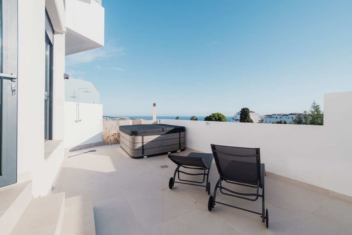 Rooftop terrace with sea view, hot tub, and lounge chairs