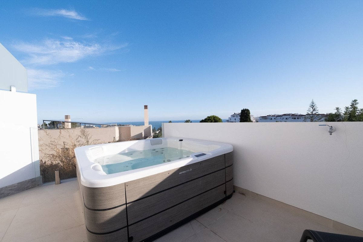Rooftop jacuzzi with sea view and clear blue sky