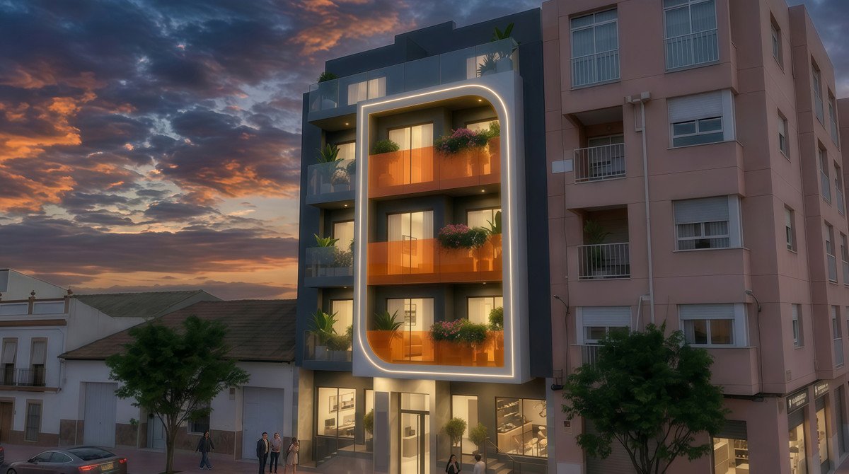Modern apartment building at sunset with illuminated balconies featuring plants and orange railings.