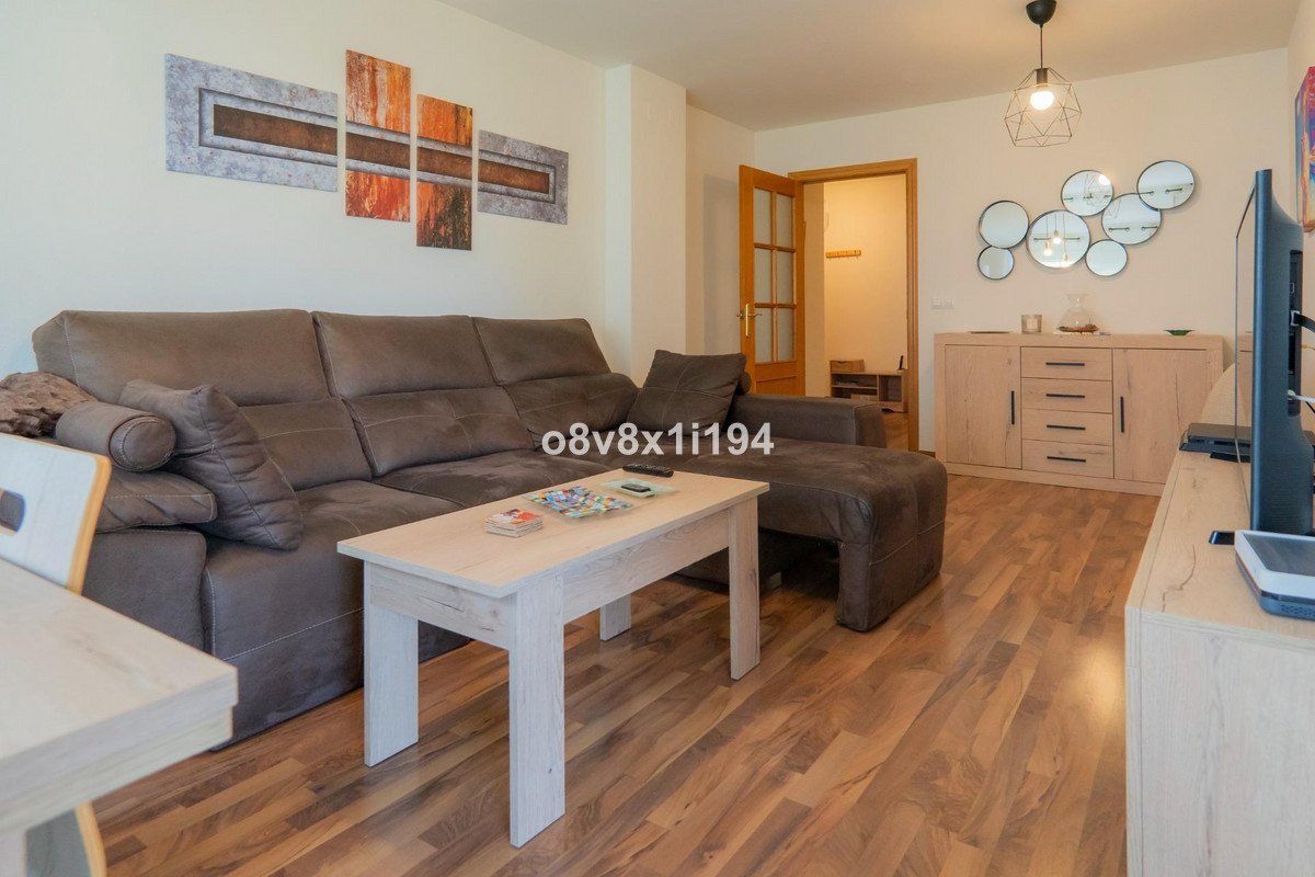 Modern living room with a large sectional sofa, a light wood coffee table, and abstract wall art.