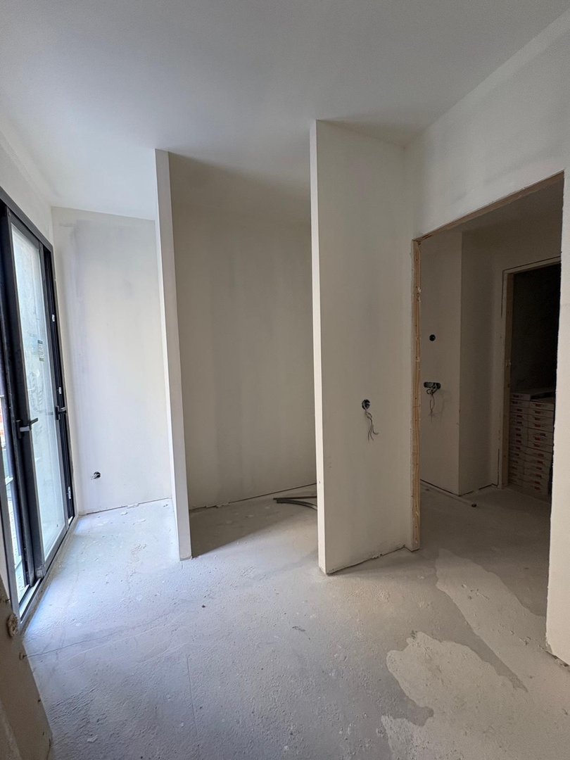 Interior space with unfinished walls, floors, and doorways, showing potential for a new build or renovation.
