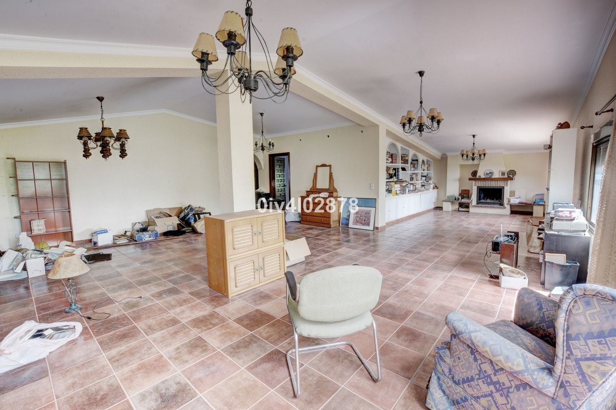 Spacious living room featuring a fireplace, built-in shelves, and tiled floors. Ready for staging.