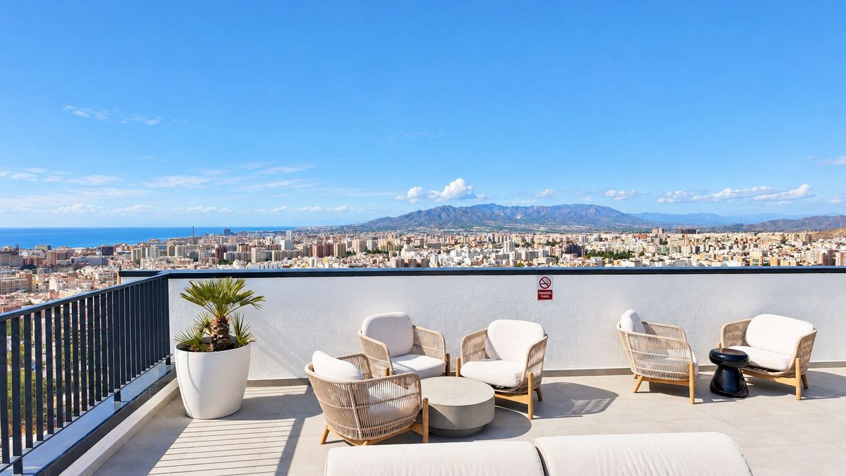 Modern terrace with comfortable seating and a panoramic view of a city and the sea.